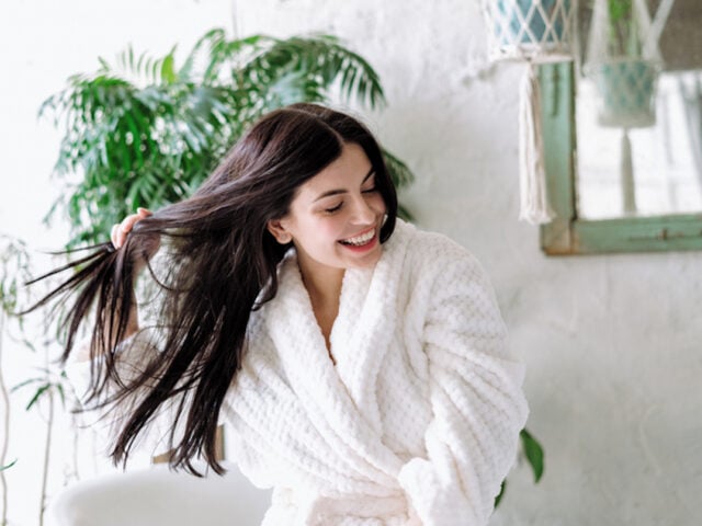 Fo-Ti benefits for hair health. Woman holding her healthy strong hair.